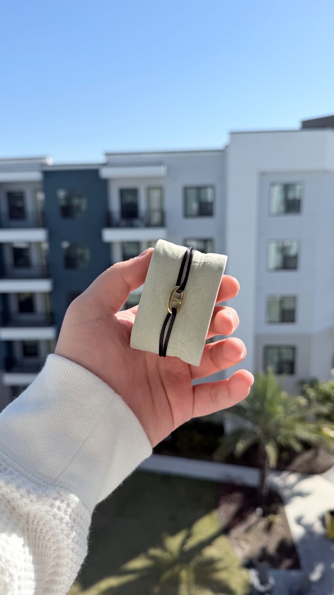 Noir Boucle black cord bracelet with gold buckle