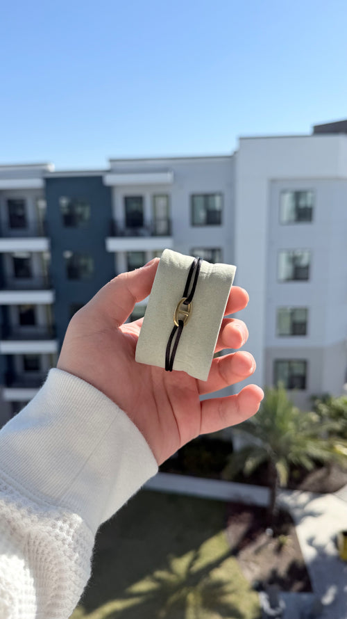 Noir Boucle black cord bracelet with gold buckle